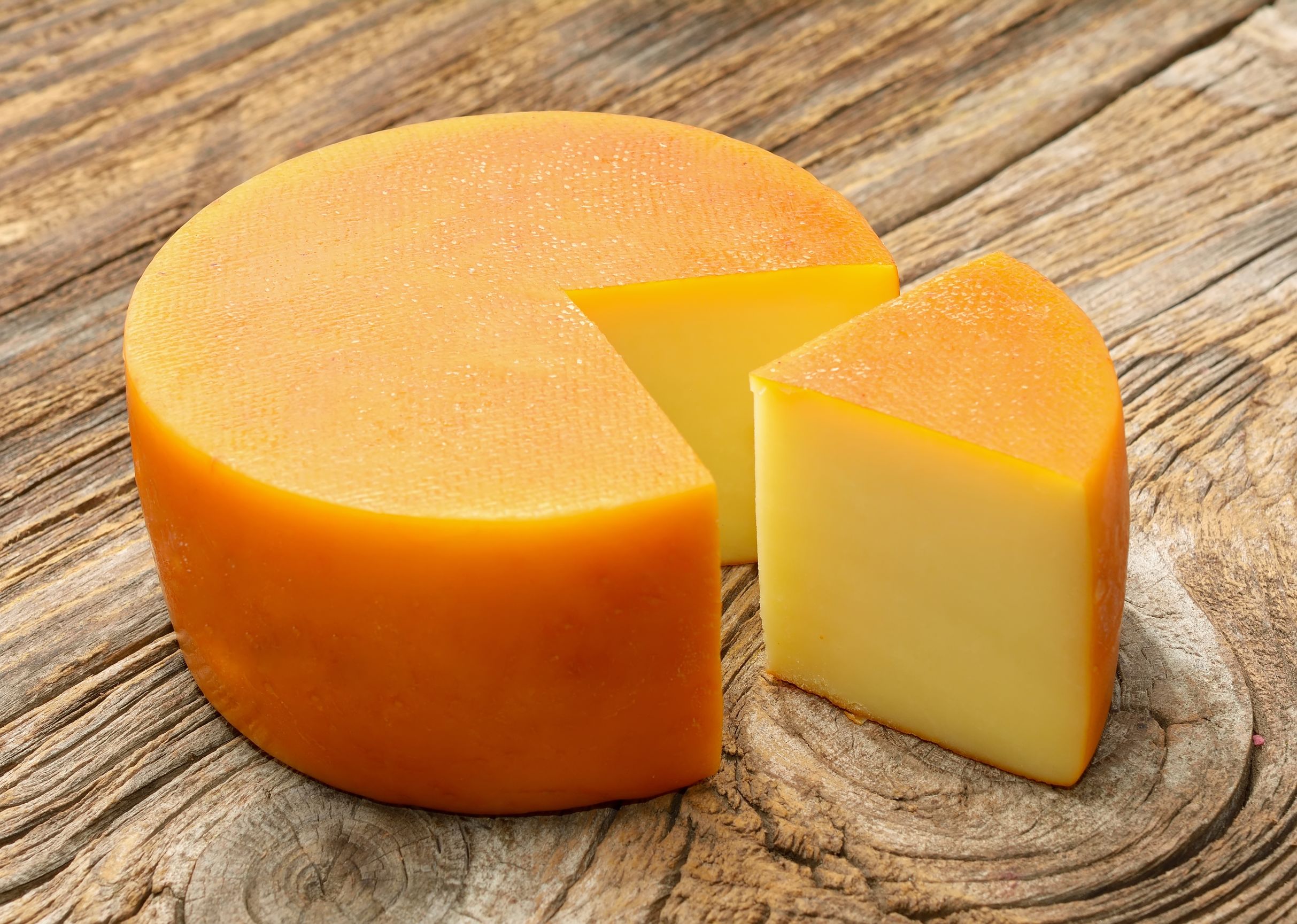 "Artisan Grouse cheese on a rustic wooden board"
